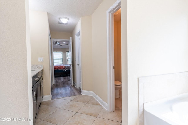 11115 Parkside Preserve Way, Jacksonville, FL 32257 - ensuite bathroom with a garden tub, vanity, tile patterned flooring, and a textured ceiling