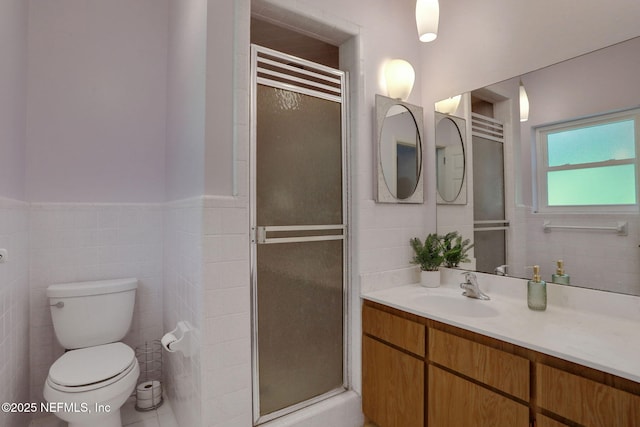 2785 Holly Point Rd E, Orange Park, FL 32073 - full bathroom featuring tile walls, a stall shower, vanity, and a wainscoted wall
