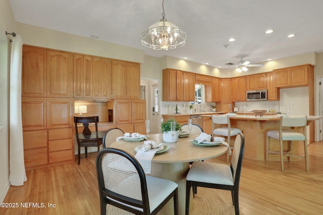 2785 Holly Point Rd E, Orange Park, FL 32073 - dining room featuring light wood-style floors, a ceiling fan, recessed lighting, and a chandelier