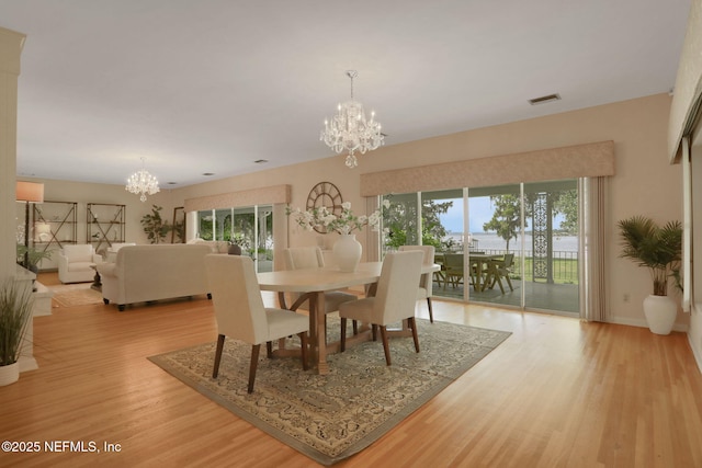 2785 Holly Point Rd E, Orange Park, FL 32073 - dining area featuring a chandelier and light wood-style floors