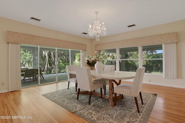 2785 Holly Point Rd E, Orange Park, FL 32073 - dining area with a chandelier and light wood-style flooring