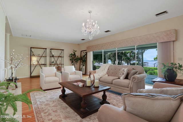 2785 Holly Point Rd E, Orange Park, FL 32073 - living room with wood finished floors and a chandelier