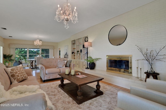 2785 Holly Point Rd E, Orange Park, FL 32073 - living area with a chandelier, wood finished floors, and a glass covered fireplace