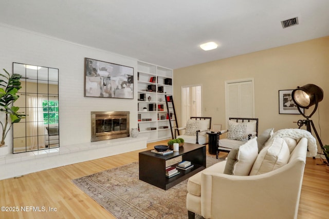 2785 Holly Point Rd E, Orange Park, FL 32073 - living area featuring wood finished floors, a glass covered fireplace, and built in shelves