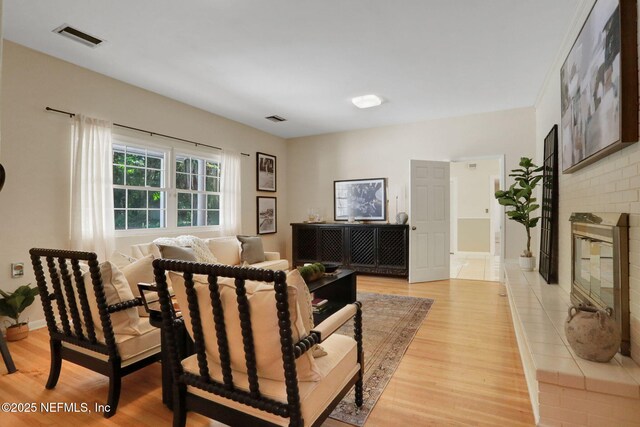2785 Holly Point Rd E, Orange Park, FL 32073 - living room with light wood finished floors and a brick fireplace