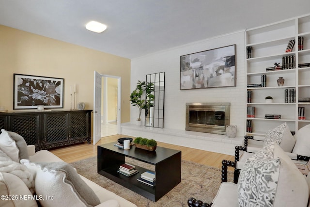 2785 Holly Point Rd E, Orange Park, FL 32073 - living area featuring wood finished floors and a brick fireplace
