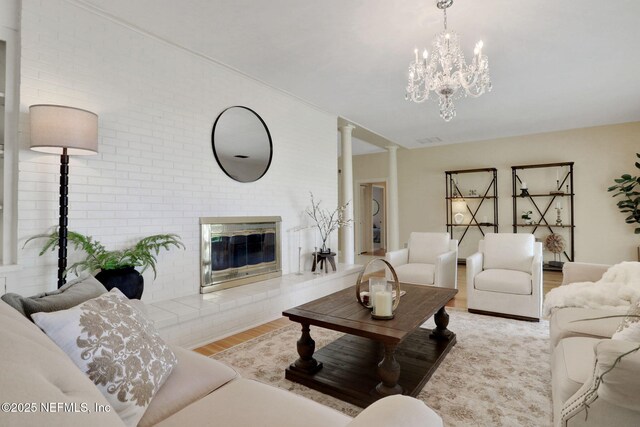 2785 Holly Point Rd E, Orange Park, FL 32073 - living area featuring wood finished floors, a chandelier, and a fireplace