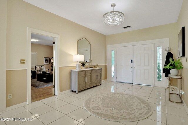 2785 Holly Point Rd E, Orange Park, FL 32073 - entrance foyer with a chandelier, healthy amount of natural light, and light tile patterned floors