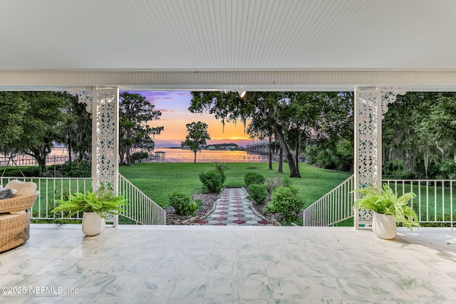 2785 Holly Point Rd E, Orange Park, FL 32073 - patio terrace at dusk featuring a lawn and a patio
