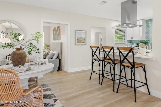 165 Sherry Dr, Atlantic Beach, FL 32233 - dining room featuring light wood-style floors and baseboards