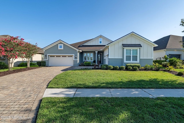 168 Bronson Pkwy, Saint Augustine, FL 32095 - view of front of house featuring board and batten siding, an attached garage, decorative driveway, and a front lawn