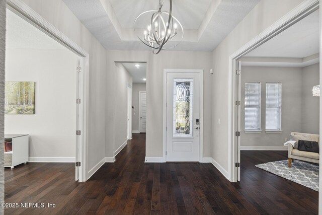 168 Bronson Pkwy, Saint Augustine, FL 32095 - entrance foyer with a chandelier, hardwood / wood-style flooring, a tray ceiling, and healthy amount of natural light