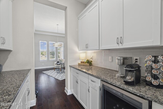 168 Bronson Pkwy, Saint Augustine, FL 32095 - kitchen with wine cooler, backsplash, dark wood-style floors, and dark stone countertops