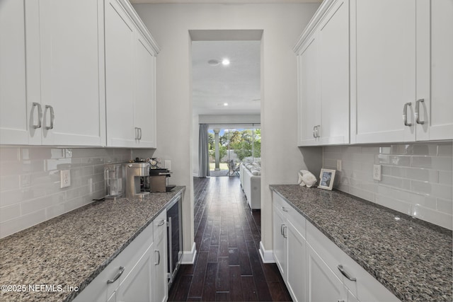 168 Bronson Pkwy, Saint Augustine, FL 32095 - kitchen with dark wood-style flooring, dark stone counters, white cabinets, decorative backsplash, and recessed lighting