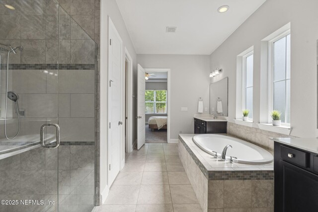 168 Bronson Pkwy, Saint Augustine, FL 32095 - full bathroom featuring vanity, a garden tub, a stall shower, connected bathroom, and tile patterned floors
