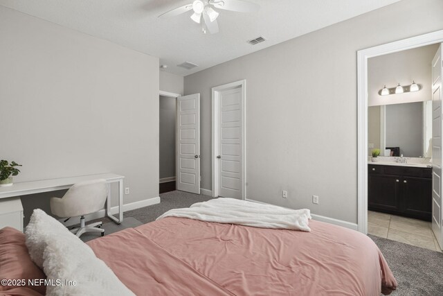 168 Bronson Pkwy, Saint Augustine, FL 32095 - bedroom with light colored carpet, a ceiling fan, and ensuite bathroom
