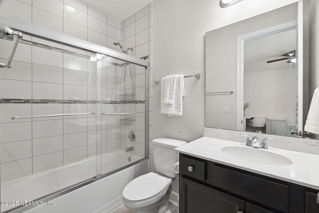 168 Bronson Pkwy, Saint Augustine, FL 32095 - bathroom with bath / shower combo with glass door, vanity, and ceiling fan