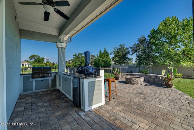 168 Bronson Pkwy, Saint Augustine, FL 32095 - fenced backyard featuring a fire pit, exterior kitchen, a patio, and a ceiling fan