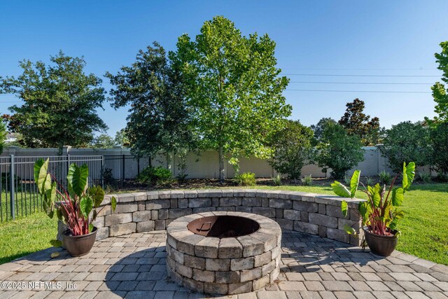 168 Bronson Pkwy, Saint Augustine, FL 32095 - fenced backyard featuring a fire pit and a patio