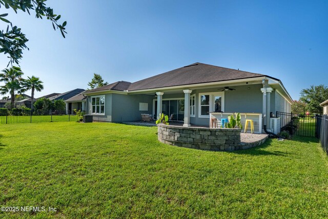 168 Bronson Pkwy, Saint Augustine, FL 32095 - rear view of house with ceiling fan, a fenced backyard, a patio area, and stucco siding