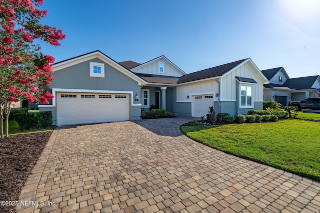 168 Bronson Pkwy, Saint Augustine, FL 32095 - view of front facade featuring board and batten siding, a garage, decorative driveway, and a front yard
