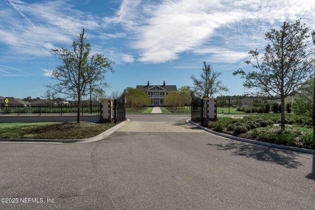 168 Bronson Pkwy, Saint Augustine, FL 32095 - view of asphalt road featuring curbs, a gated entry, and a gate