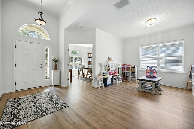 6105 Caladesi Ct, Jacksonville, FL 32258 - foyer with crown molding, wood finished floors, and a textured ceiling