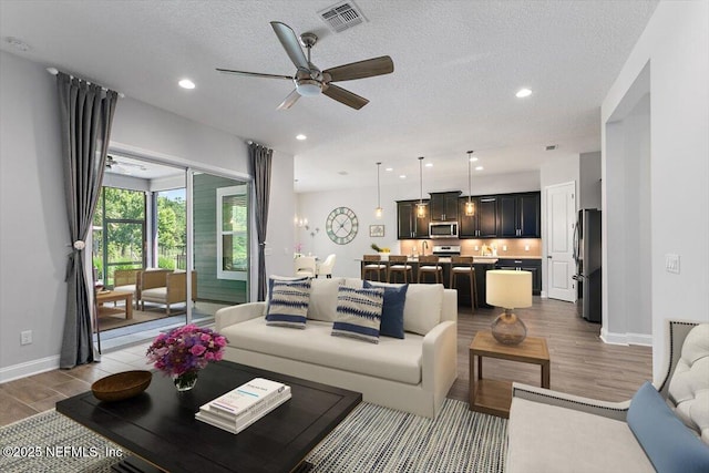 150 Calumet Dr, Saint Johns, FL 32259 - living area with light wood finished floors, a ceiling fan, a textured ceiling, and recessed lighting