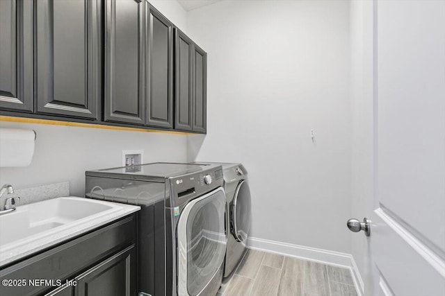 150 Calumet Dr, Saint Johns, FL 32259 - washroom featuring cabinet space, washer and clothes dryer, and light wood-style flooring