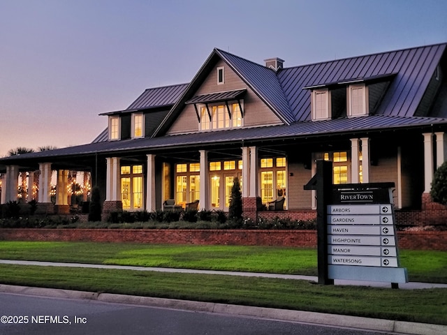 150 Calumet Dr, Saint Johns, FL 32259 - view of front facade featuring a standing seam roof, a yard, brick siding, and a metal roof