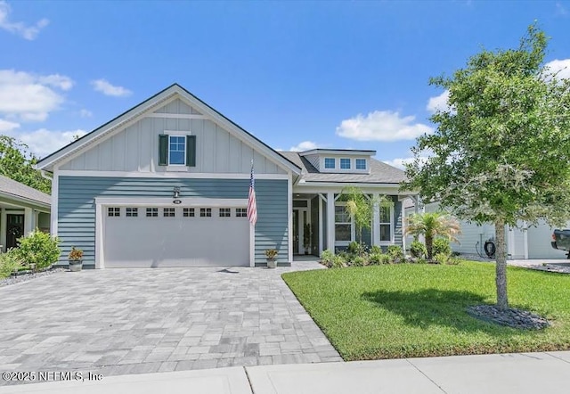 150 Calumet Dr, Saint Johns, FL 32259 - craftsman house with board and batten siding, a front lawn, an attached garage, and decorative driveway