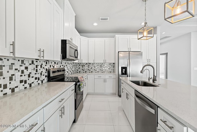 20 Evansville Ln, Palm Coast, FL 32164 - kitchen with appliances with stainless steel finishes, white cabinets, backsplash, decorative light fixtures, and recessed lighting