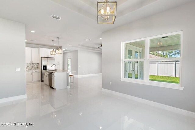 20 Evansville Ln, Palm Coast, FL 32164 - unfurnished living room featuring a chandelier and recessed lighting
