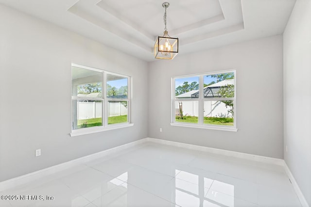 20 Evansville Ln, Palm Coast, FL 32164 - unfurnished room featuring plenty of natural light, a chandelier, light tile patterned flooring, and a tray ceiling