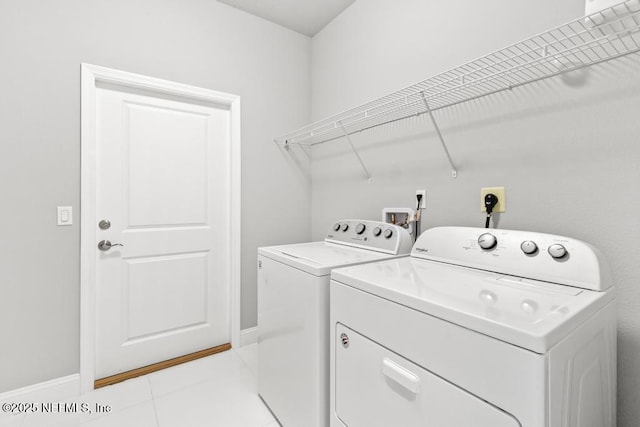 20 Evansville Ln, Palm Coast, FL 32164 - laundry area featuring washing machine and clothes dryer and light tile patterned flooring