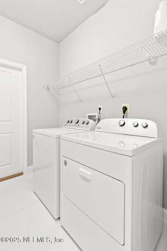 20 Evansville Ln, Palm Coast, FL 32164 - washroom featuring washing machine and clothes dryer and light tile patterned floors
