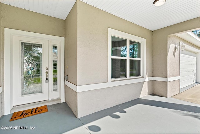 20 Evansville Ln, Palm Coast, FL 32164 - property entrance with stucco siding and an attached garage