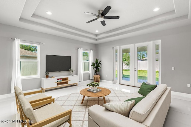 20 Evansville Ln, Palm Coast, FL 32164 - living area featuring a tray ceiling, healthy amount of natural light, a ceiling fan, recessed lighting, and french doors