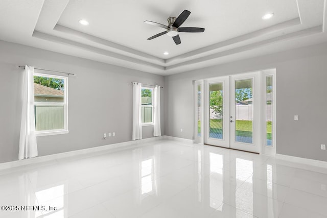 20 Evansville Ln, Palm Coast, FL 32164 - spare room with a raised ceiling, healthy amount of natural light, french doors, a ceiling fan, and recessed lighting