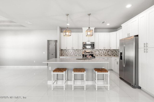20 Evansville Ln, Palm Coast, FL 32164 - kitchen with stainless steel appliances, light tile patterned flooring, a kitchen bar, backsplash, and recessed lighting