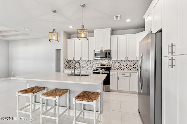 20 Evansville Ln, Palm Coast, FL 32164 - kitchen featuring stainless steel appliances, a kitchen breakfast bar, tasteful backsplash, white cabinetry, and recessed lighting