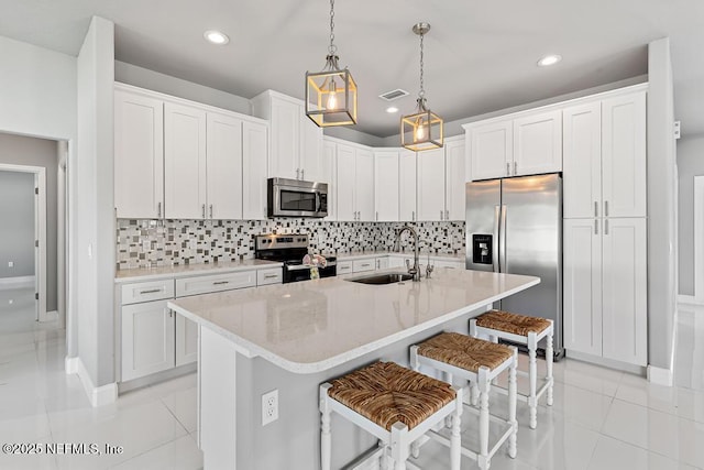 20 Evansville Ln, Palm Coast, FL 32164 - kitchen featuring stainless steel appliances, a breakfast bar, recessed lighting, tasteful backsplash, and hanging light fixtures