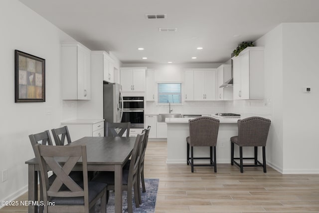 174 Torres Trce, Saint Augustine, FL 32095 - kitchen featuring a peninsula, white cabinetry, light countertops, and recessed lighting