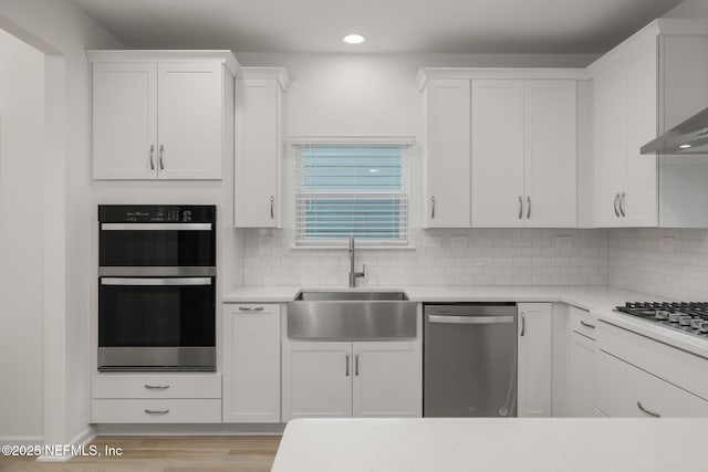 174 Torres Trce, Saint Augustine, FL 32095 - kitchen with appliances with stainless steel finishes, light countertops, white cabinets, tasteful backsplash, and recessed lighting