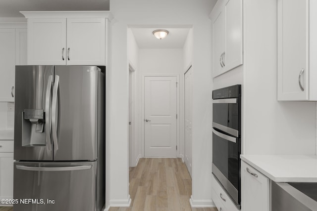 174 Torres Trce, Saint Augustine, FL 32095 - kitchen with stainless steel refrigerator with ice dispenser, white cabinets, light wood-style floors, and light countertops