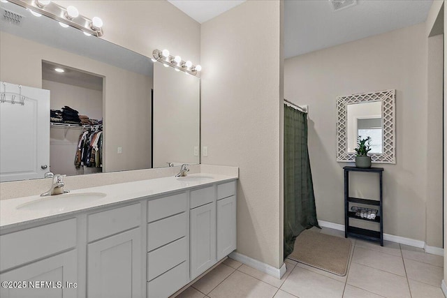 235 Brybar Dr, Saint Augustine, FL 32095 - full bath featuring double vanity, tile patterned flooring, a walk in closet, and curtained shower