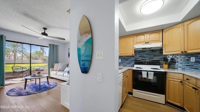 4250 A1A Unit B16, Saint Augustine, FL 32080 - kitchen with white appliances, under cabinet range hood, light wood finished floors, backsplash, and a textured ceiling
