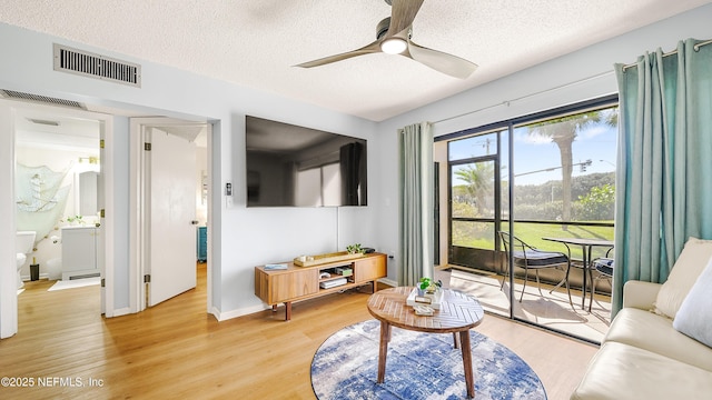 4250 A1A Unit B16, Saint Augustine, FL 32080 - living area with a textured ceiling, light wood-style floors, and a ceiling fan