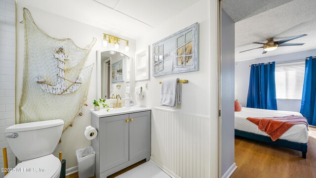 4250 A1A Unit B16, Saint Augustine, FL 32080 - bathroom with vanity, ensuite bath, wood finished floors, a ceiling fan, and wainscoting