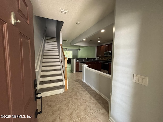 6967 Roundleaf Dr, Jacksonville, FL 32258 - staircase with tile patterned flooring and recessed lighting